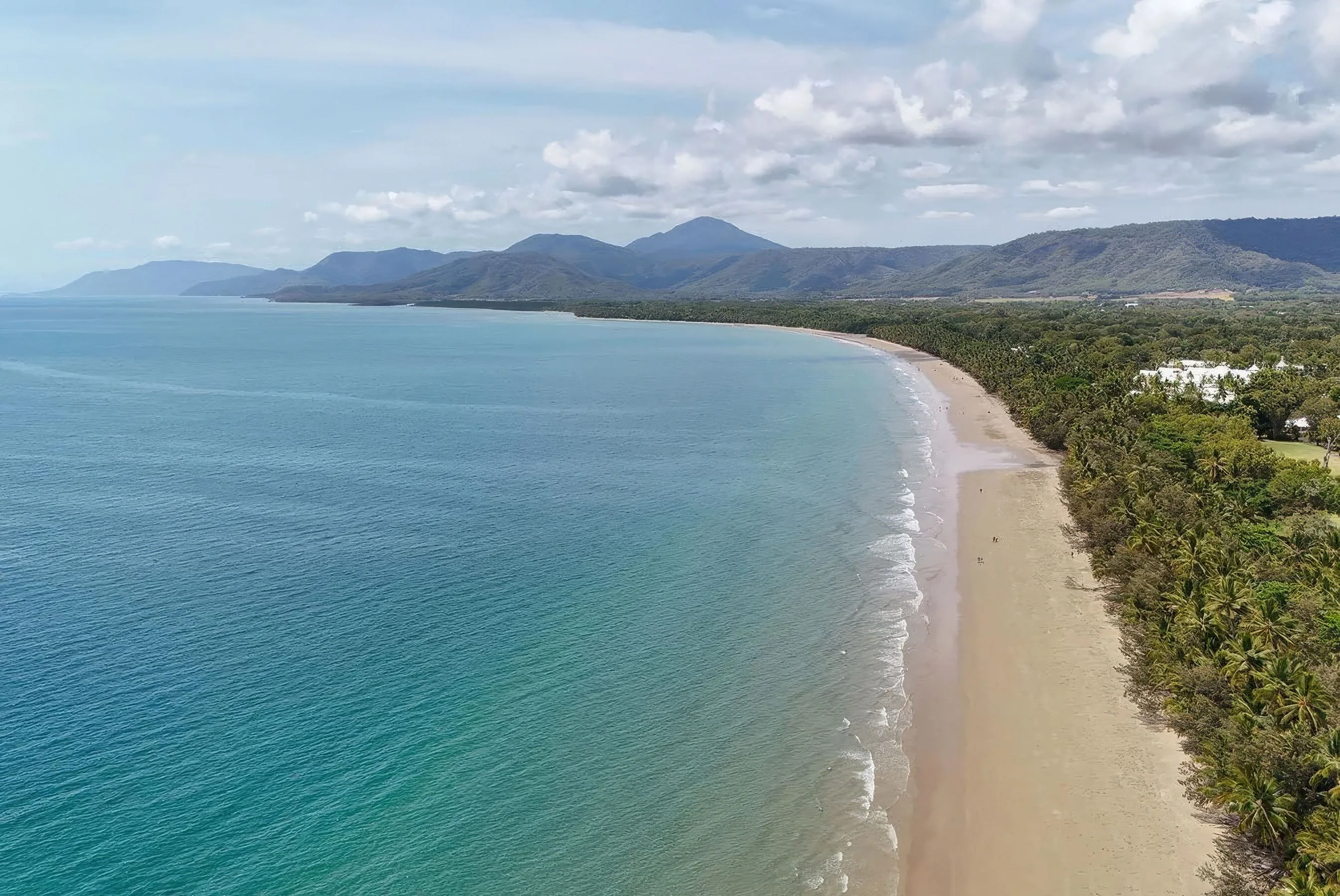Four Mile Beach stretching along the coastline in Port Douglas