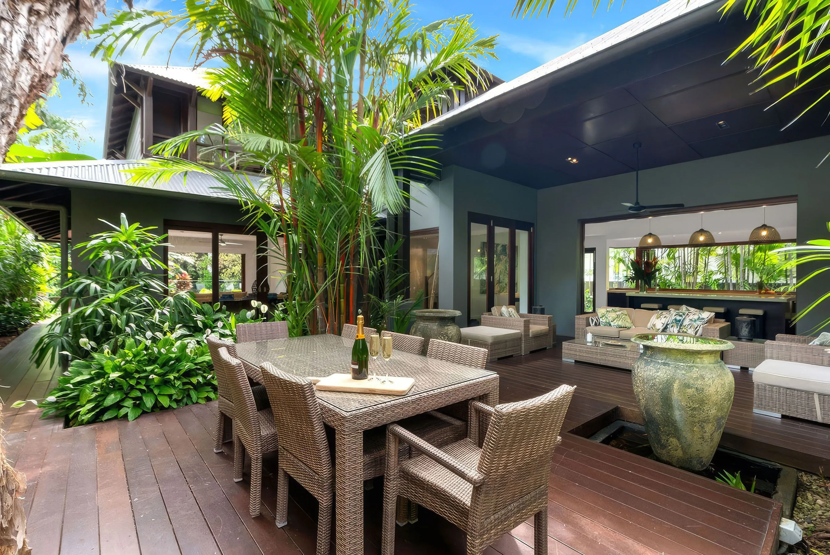 Outdoor dining beneath the established tropical trees