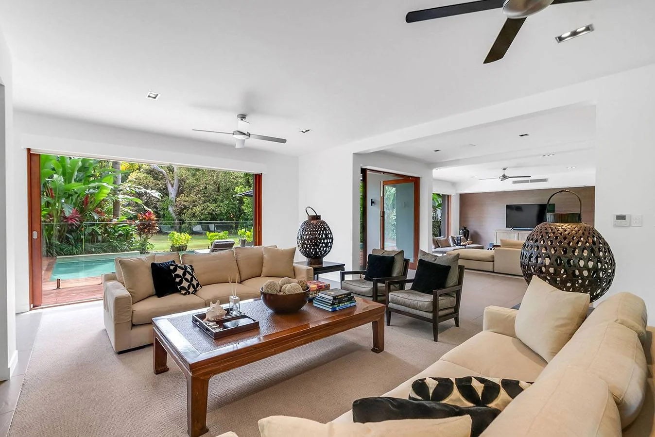 Living spaces opening to the tropical garden