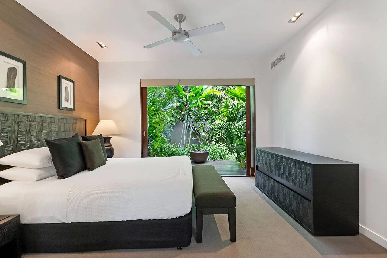The primary suite opening to lush tropical planting