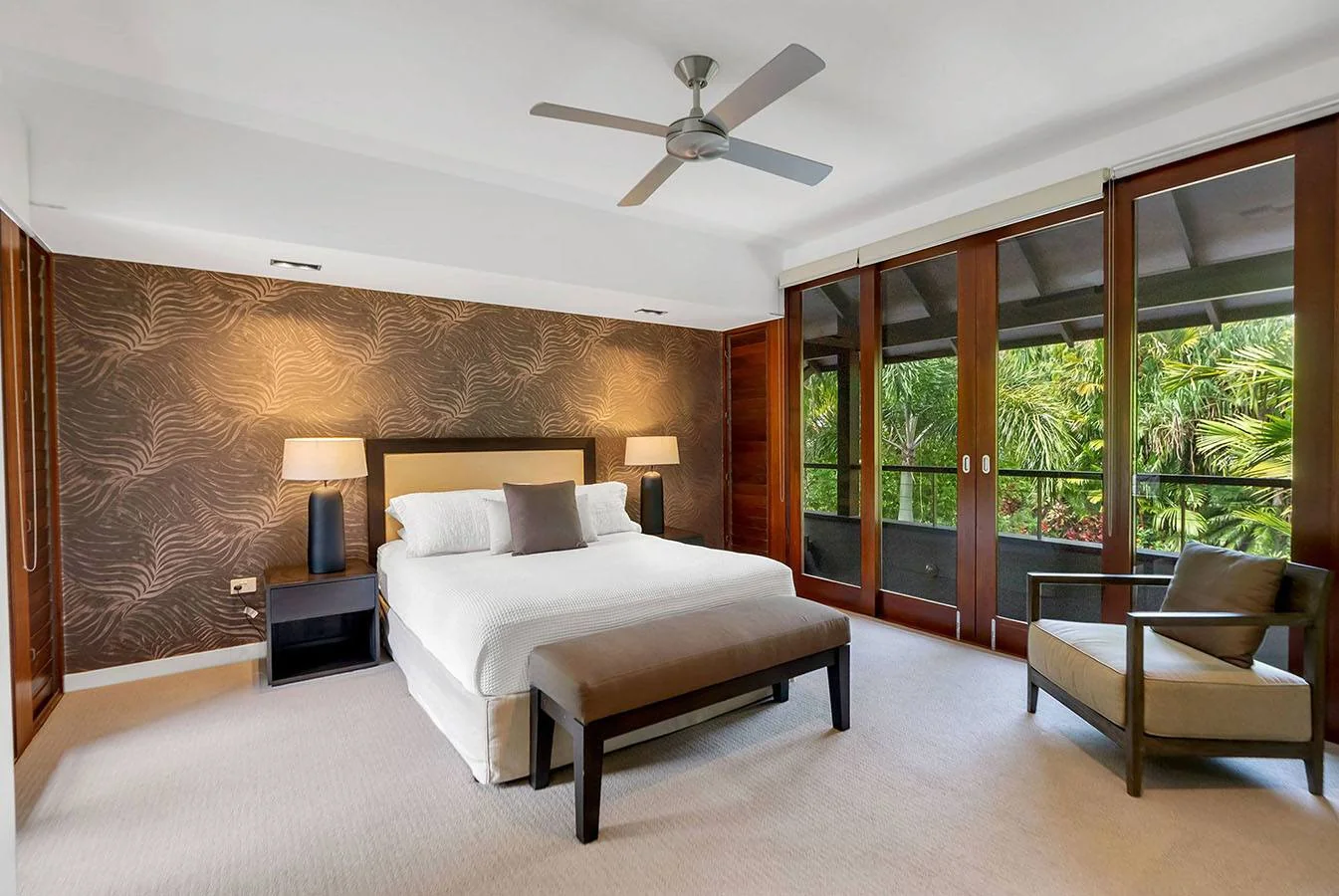 A tranquil bedroom with timber finishes and a private balcony